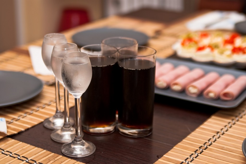 three glasses with cold vodka and three glasses of cola