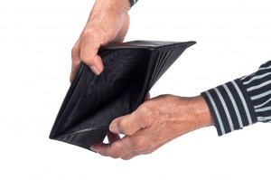 Elderly hands holding an empty wallet isolated