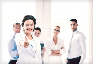 businesswoman in office showing thumbs up