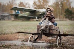 Young boy-pilot in the plane at the airport handmade autumn